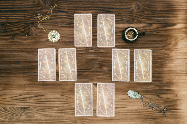istock Foreteller. Future teller. Tarot cards on wooden table. 925830754