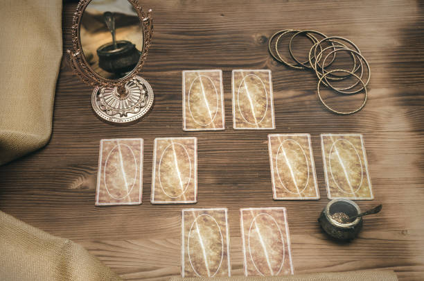 istock Foreteller. Future teller. Tarot cards on wooden table. 925830806