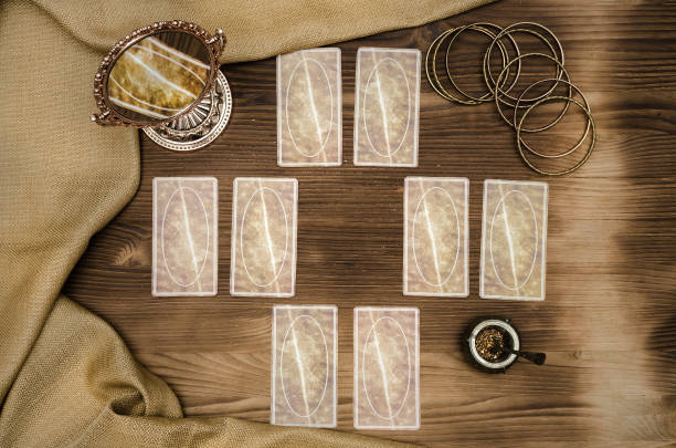 istock Foreteller. Future teller. Tarot cards on wooden table. 925831228