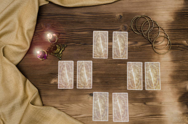 istock Foreteller. Future teller. Tarot cards on wooden table. 925831234
