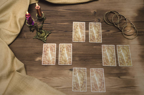 istock Foreteller. Future teller. Tarot cards on wooden table. 925831238