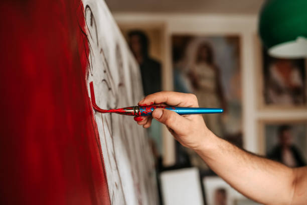istock Painting red. Artist working on artwork. 925831636