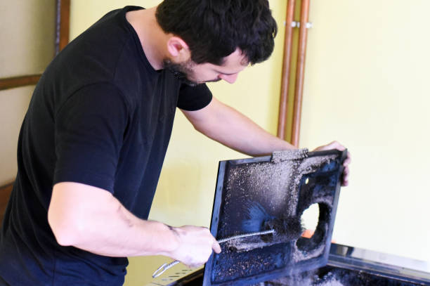 istock Man cleaning wood burning stove 925839798