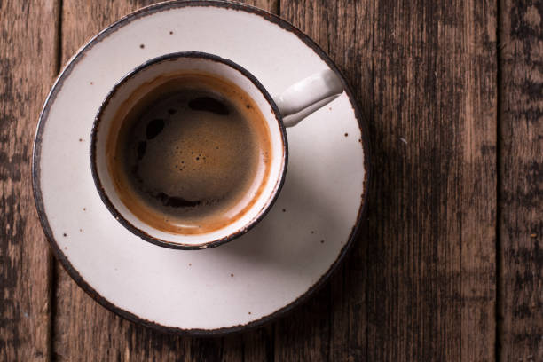 istock coffee cup and coffee beans on vintage wooden background 925850162
