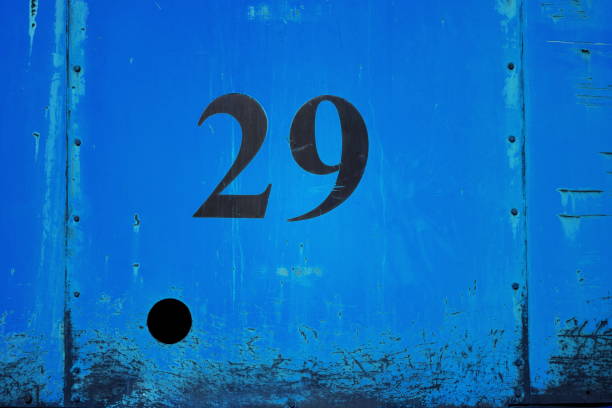 istock Number 29 on blue orange metal sheet plate with hole 925854056