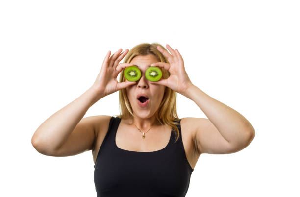 girl with sliced fruits - facial expression isolated lifestyles exoticism imagens e fotografias de stock