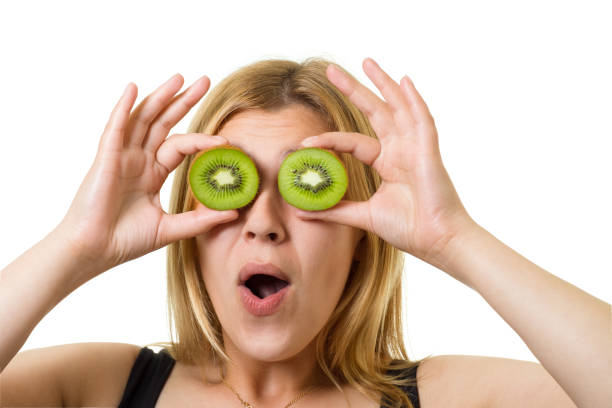 girl with sliced fruits - facial expression isolated lifestyles exoticism imagens e fotografias de stock