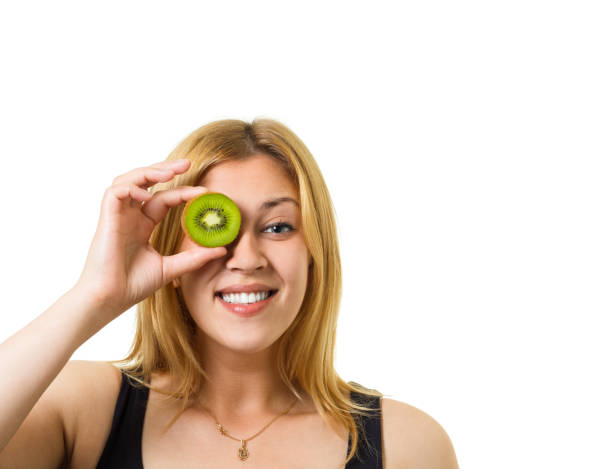 girl with sliced fruits - facial expression isolated lifestyles exoticism imagens e fotografias de stock