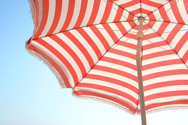 Close-up of red and white striped beach umbrella stock photo