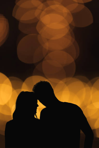 istock Silhouette of a couple with de-focused / bokeh lights. 925857012
