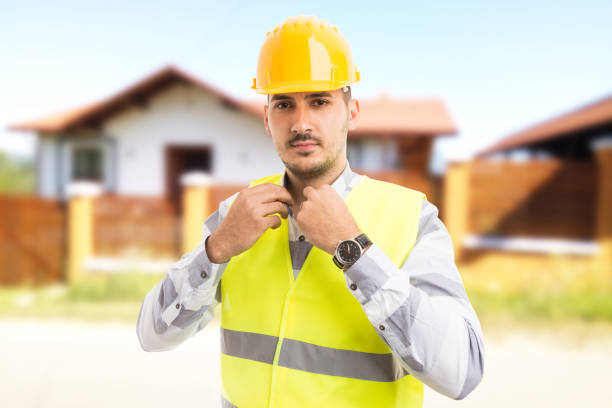 istock Proud and confident architect or constructor standing in front of new house 925857058