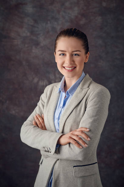 istock Elegant woman standing against dark background 925857068