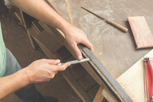 istock Carpenter working on the wood in his shop. 925857076