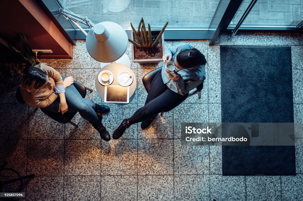 We always make time for our coffee dates Two female friends hanging out in a coffee shop Cafe Stock Photo