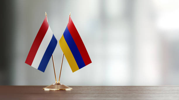 istock Armenian And Dutch Flag Pair On A Desk Over Defocused Background 925860992