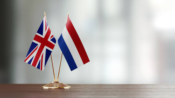 istock British And Dutch Flag Pair On A Desk Over Defocused Background 925861234