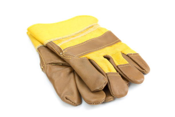 istock Yellow leather and cotton protective gloves cut out on a white background. 925861268