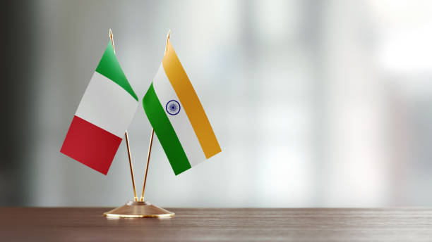 istock Italian And Indian Flag Pair On A Desk Over Defocused Background 925864116
