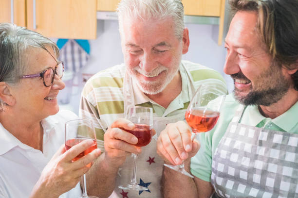 istock three people toast and laugh in the kitchen 925864404