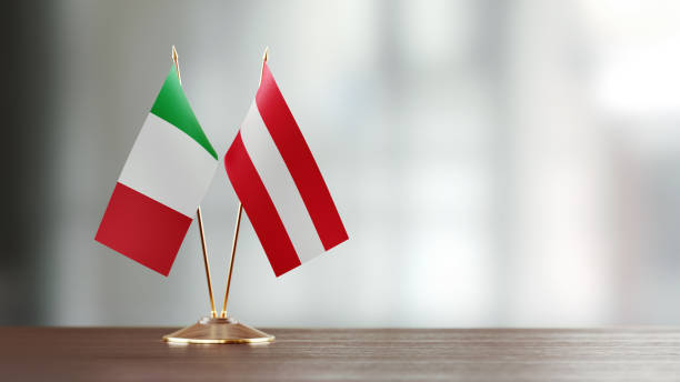 istock Italian And Austrian Flag Pair On A Desk Over Defocused Background 925870374