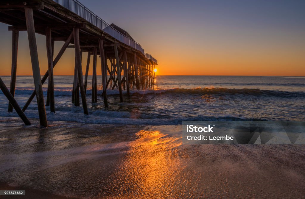 Beauty of sunlight. Morning sun shining through the fishing pier at Belmar beach, New Jerse Beach Stock Photo