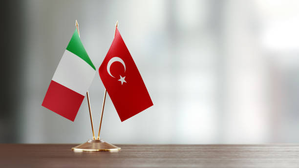 istock Italian And Turkish Flag Pair On A Desk Over Defocused Background 925873650