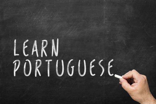 istock Human hand writing text on blackboard: Learn portuguese 925877440