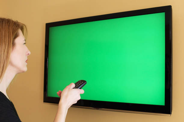 istock Woman Watching Green Screen TV 925884798