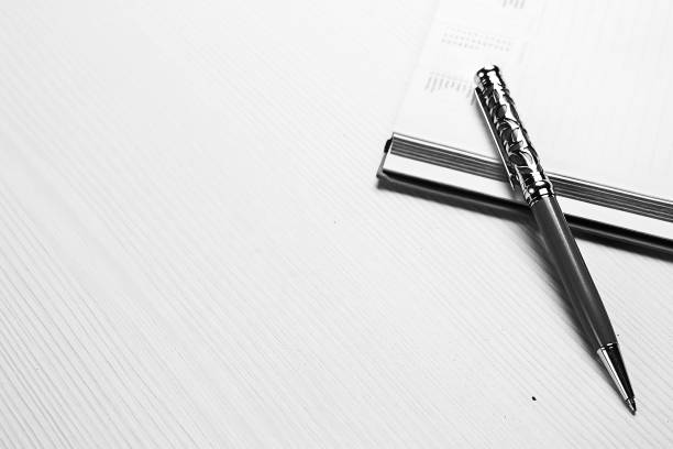 stationery lying on the table black and white poster