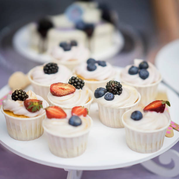 istock Different appetizing tartlets, cake basket with white cream and fresh multi-colored berries, summer dessert with blueberries, blackberries, strawberries 925902084