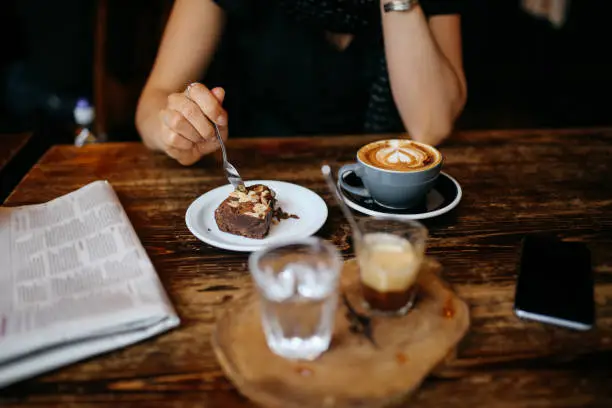 Photo of Coffee and cake on the table in a cafe in London downtown