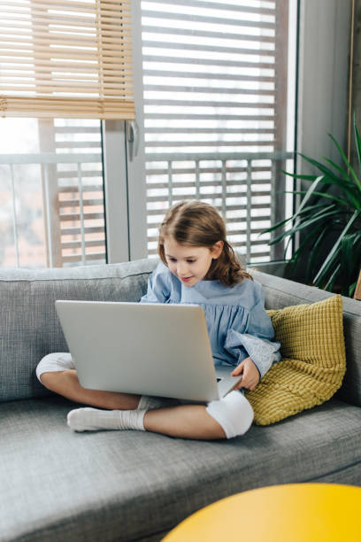 istock Little girl with laptop 925905232