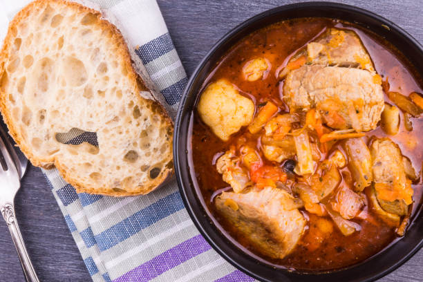istock Braised meat with vegetables in a black bowl close-up 925905430