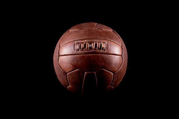istock Old football leather ball on a black background 925909394