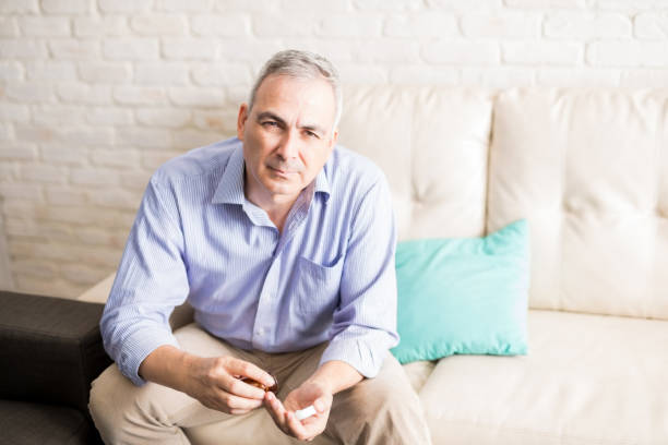 istock Sick mature man at home taking medicine 925912562