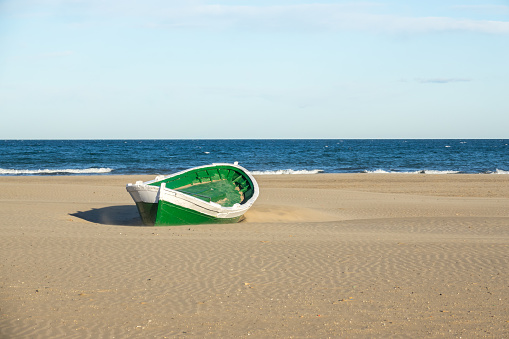Malvarrosa Valencia Spain, Malvarrosa Valencia Spain wrecked wooden boat. boat stranded in the sand of a beach Broken abandoned boat in sand, sea coast line