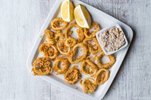 istock Fried Crispy Calamari Squid Rings with Tartar Sauce and Lemon. 925917024