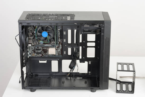 istock ATX motherboard inserted to black computer midi tower case. 925917778
