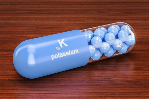 istock Potassium, kalium K capsule on the wooden table. 3D rendering 925917928