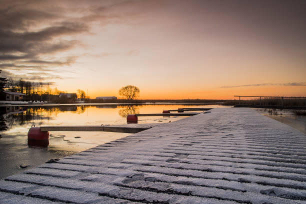 Dawn over a lake and pier.