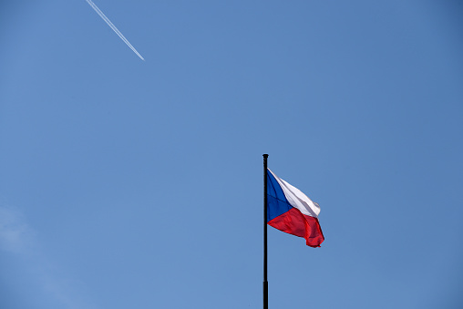 Flag of Czech Republic and contrail under clear sky. It was a day of early summer where a refreshing wind blew. Shot with Nikon D800 and Nikkor VR 28 ~ 300mm.