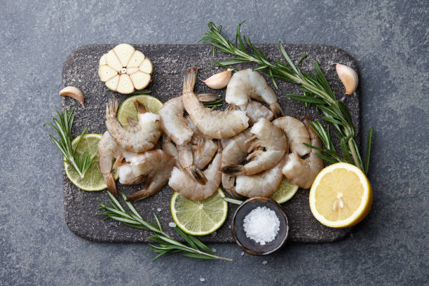 istock Cooking raw tiger prawns with herbs and spices 925930400
