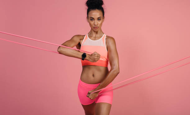 istock Tough woman exercising with resistance band 925936510