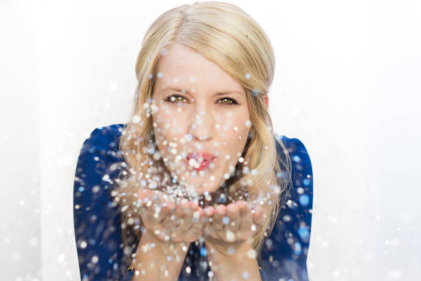 Pretty blonde girl with glitter in hands.