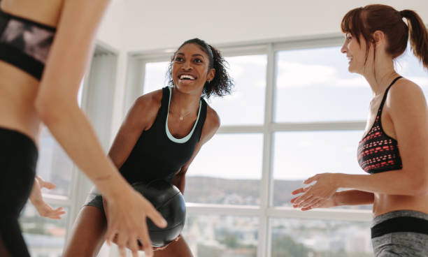 istock Smiling workout partners exercising with medicine ball 925940972