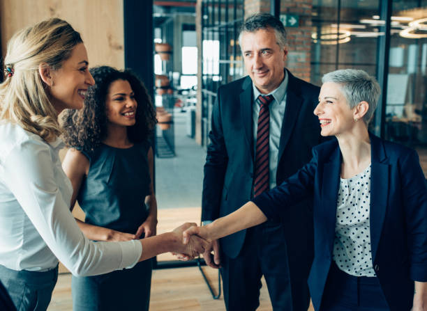 Greeting for success Business women handshaking congratulating with career achievement coalition photos stock pictures, royalty-free photos & images