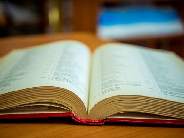istock opened book on the table close up in the school 925943142