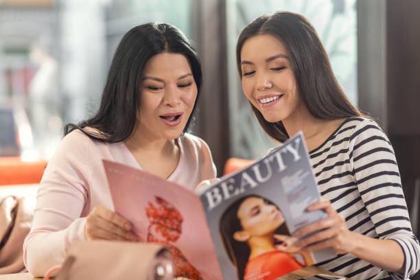 istock Delighted positive women reading a magazine 925951612