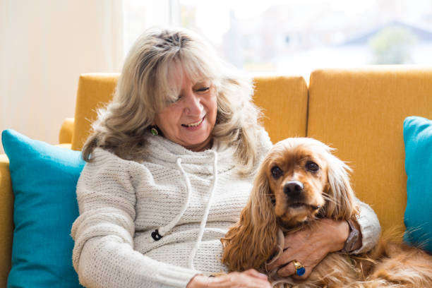 istock Grandma playing with her dog 925952856