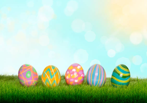 istock Colourful painted Easter Eggs on green grass and blurred garden and blue sky background. 925952874